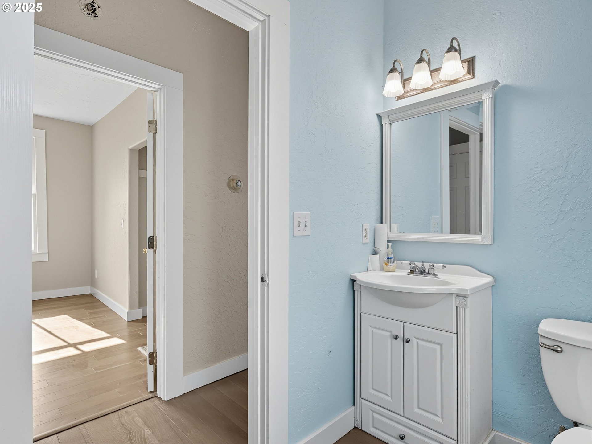 686 29th Street Astoria, OR 97103 - Photo 31 of 48 a bathroom with a toilet sink and mirror