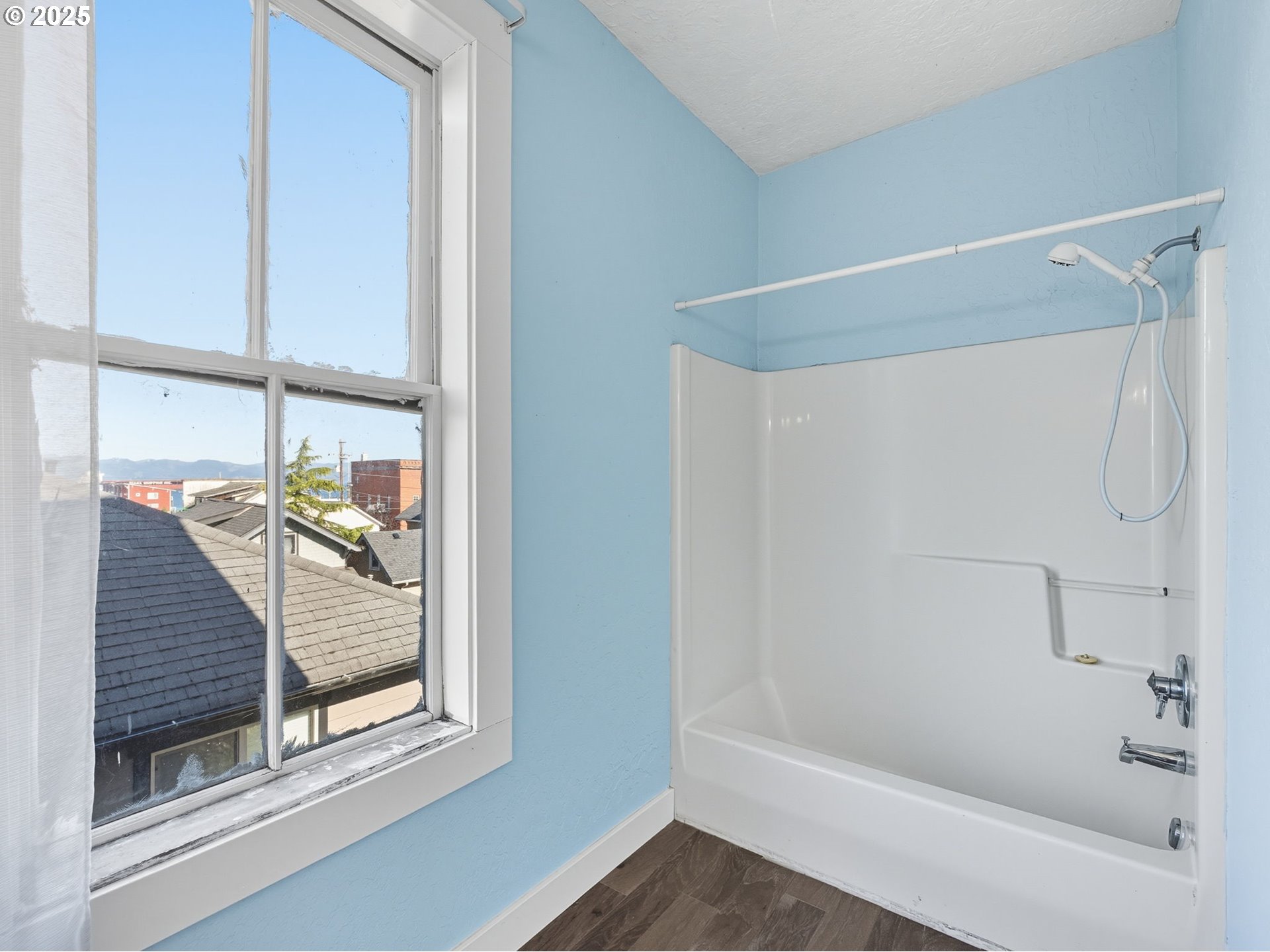 686 29th Street Astoria, OR 97103 - Photo 32 of 48 a bathroom with a glass shower door