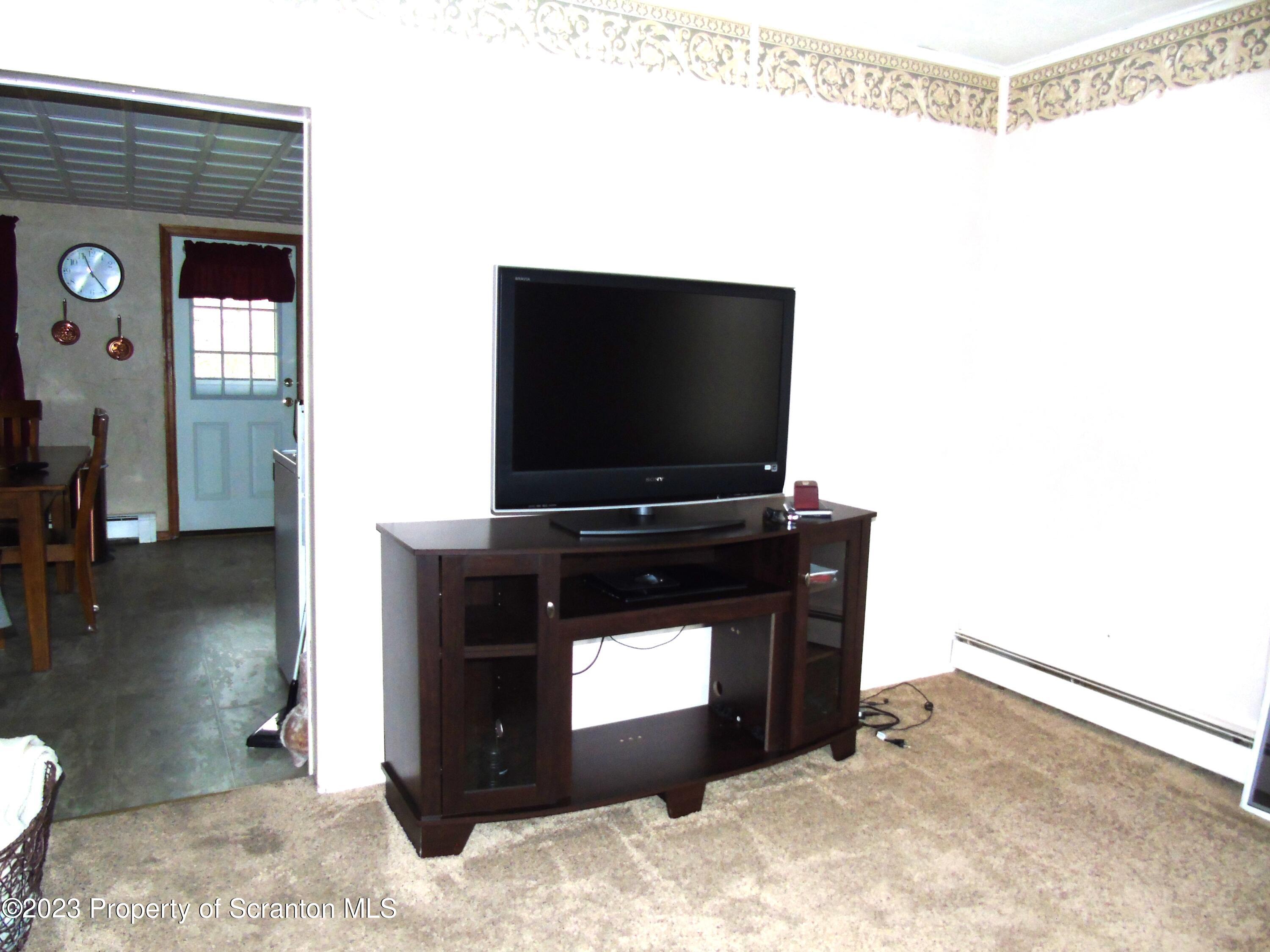 115 T Rte 718 Moscow, PA 18444 - Photo 12 of 26 a living room with a flat screen tv and a fireplace