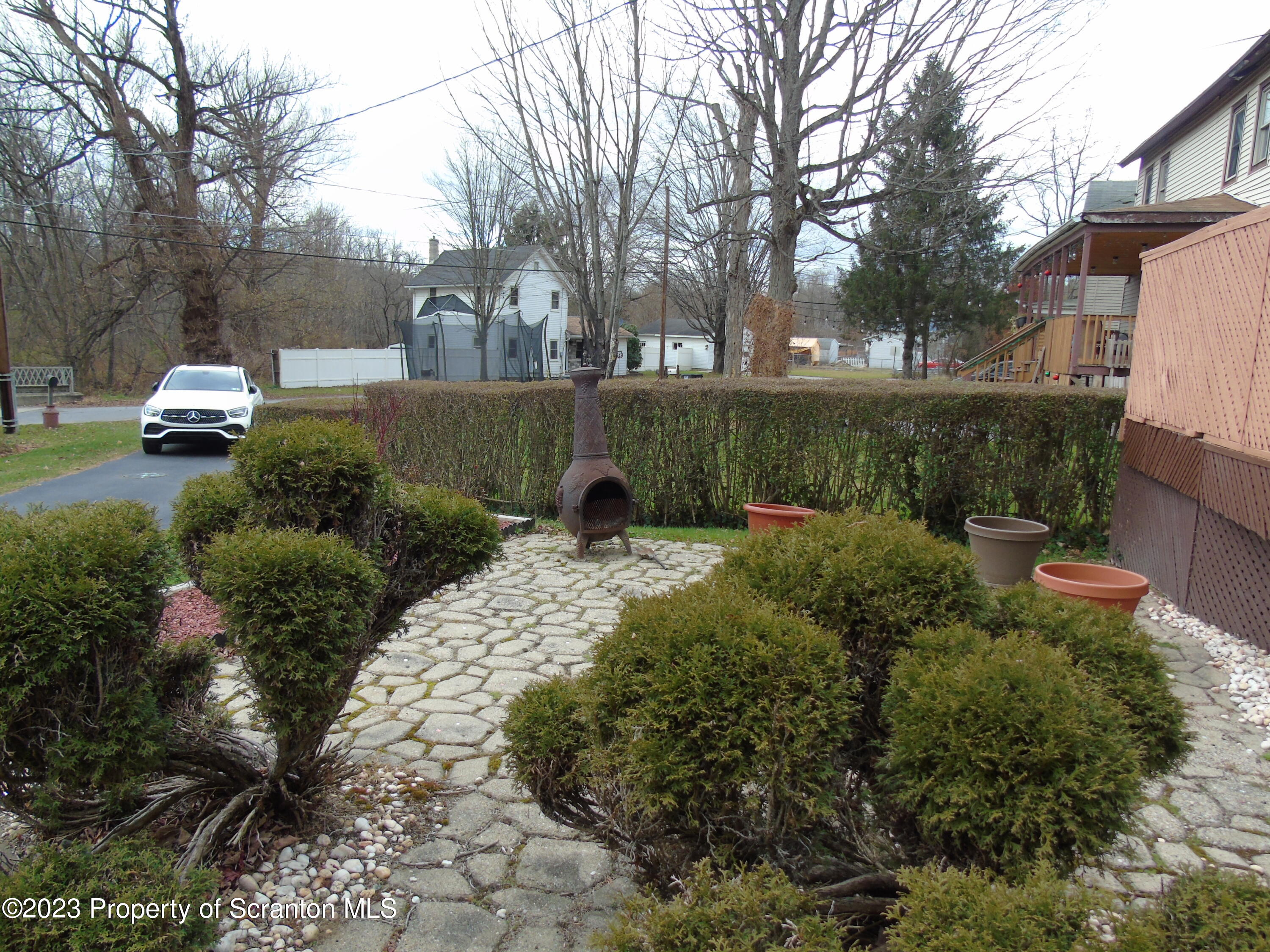 115 T Rte 718 Moscow, PA 18444 - Photo 10 of 26 a view of a garden with a bench and trees