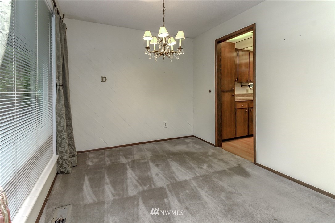 4615 Northeast 24th Street Renton, WA 98059 - Photo 12 of 40 a view of a chandelier in big room with windows and chandelier
