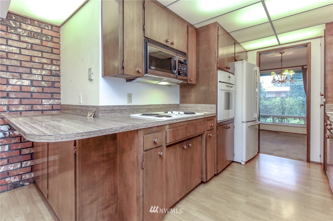 4615 Northeast 24th Street Renton, WA 98059 - Photo 15 of 40 a kitchen that has a sink a stove and a microwave oven