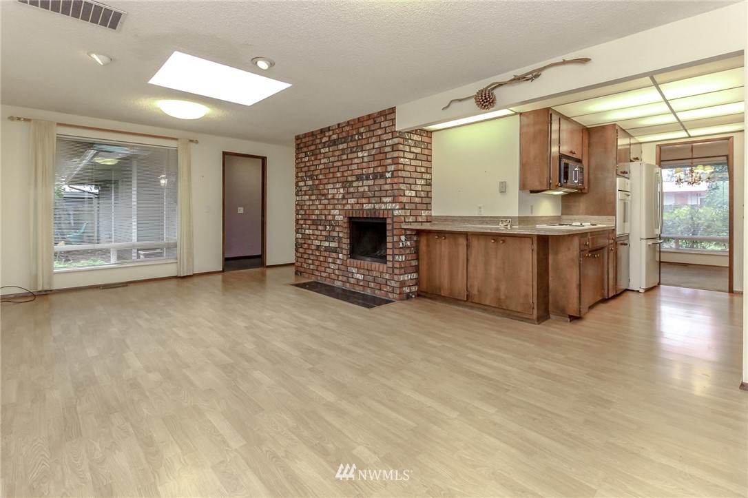 4615 Northeast 24th Street Renton, WA 98059 - Photo 17 of 40 an empty room with kitchen and fireplace
