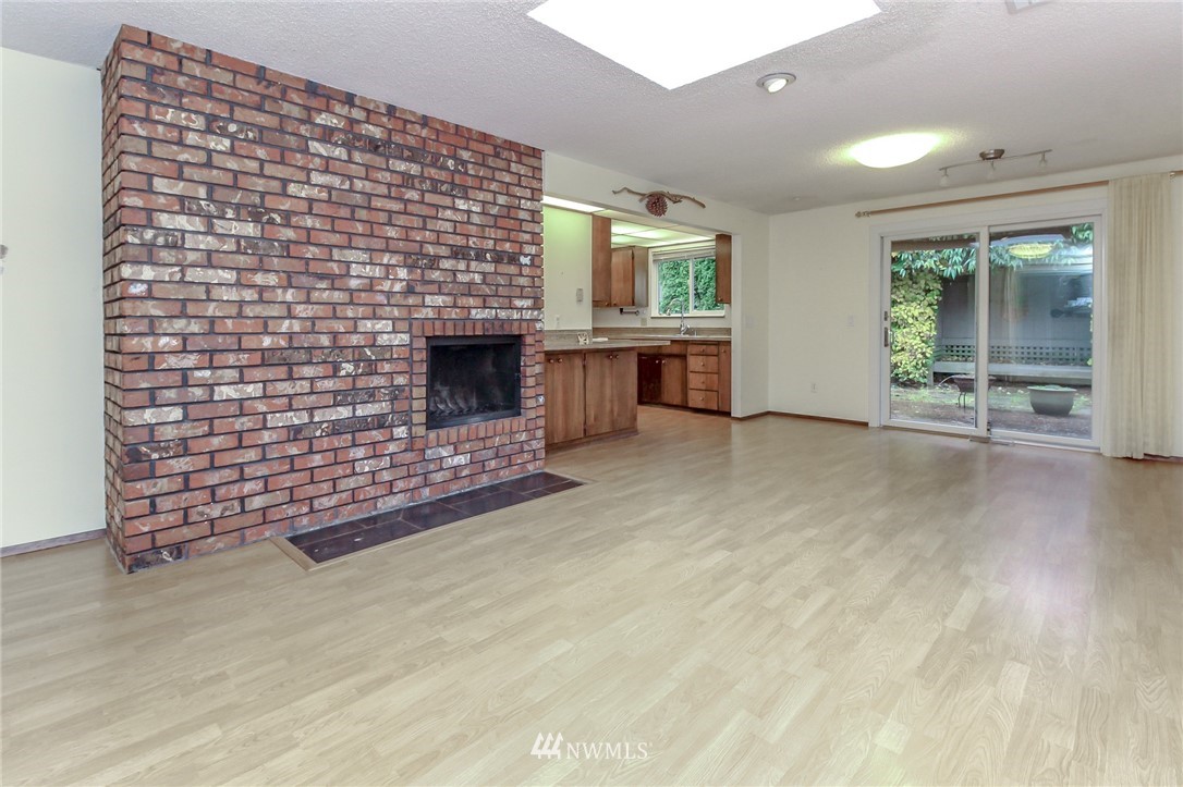 4615 Northeast 24th Street Renton, WA 98059 - Photo 18 of 40 a living room with furniture and a fireplace
