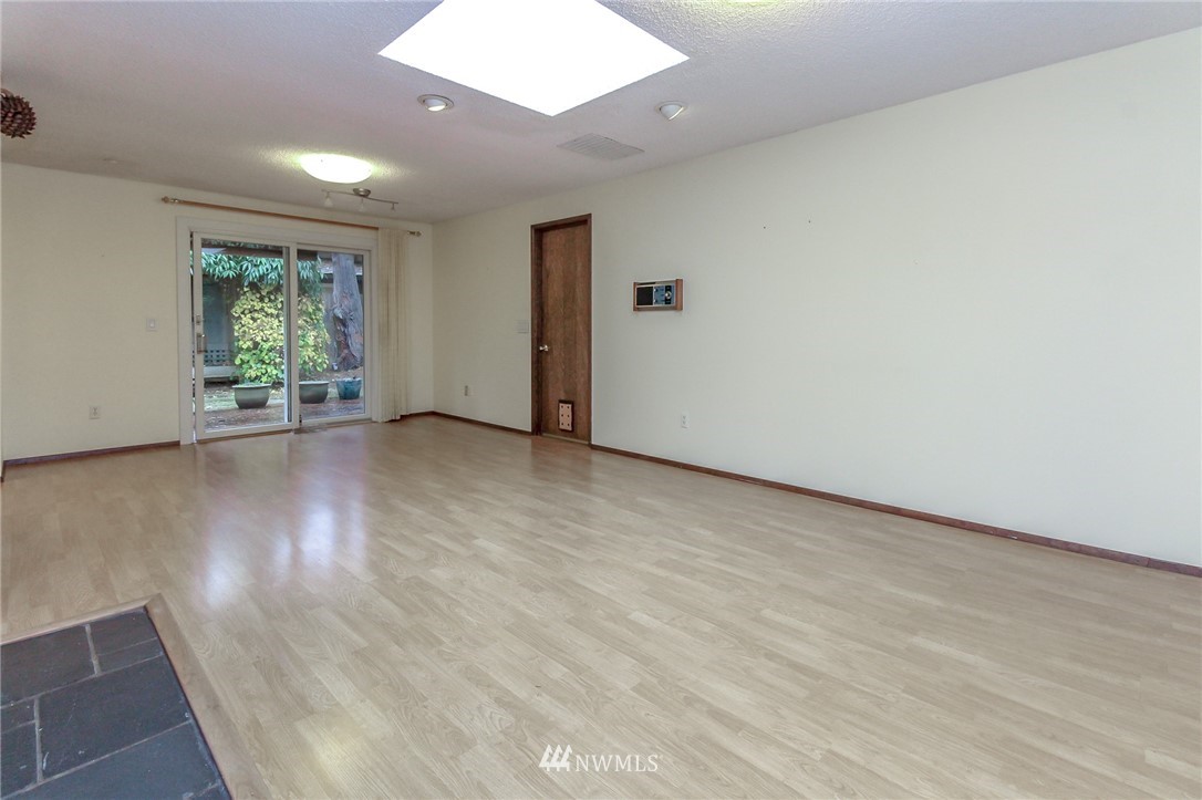 4615 Northeast 24th Street Renton, WA 98059 - Photo 19 of 40 an empty room with wooden floor and windows