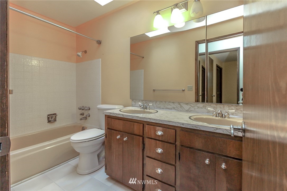 4615 Northeast 24th Street Renton, WA 98059 - Photo 22 of 40 a bathroom with a double vanity sink toilet mirror and bathtub