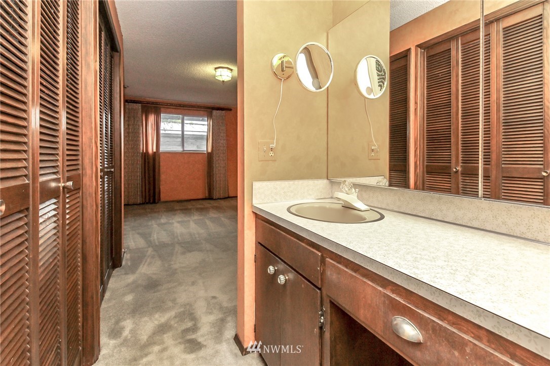 4615 Northeast 24th Street Renton, WA 98059 - Photo 31 of 40 a bathroom with a sink a granite countertop tub and a sink