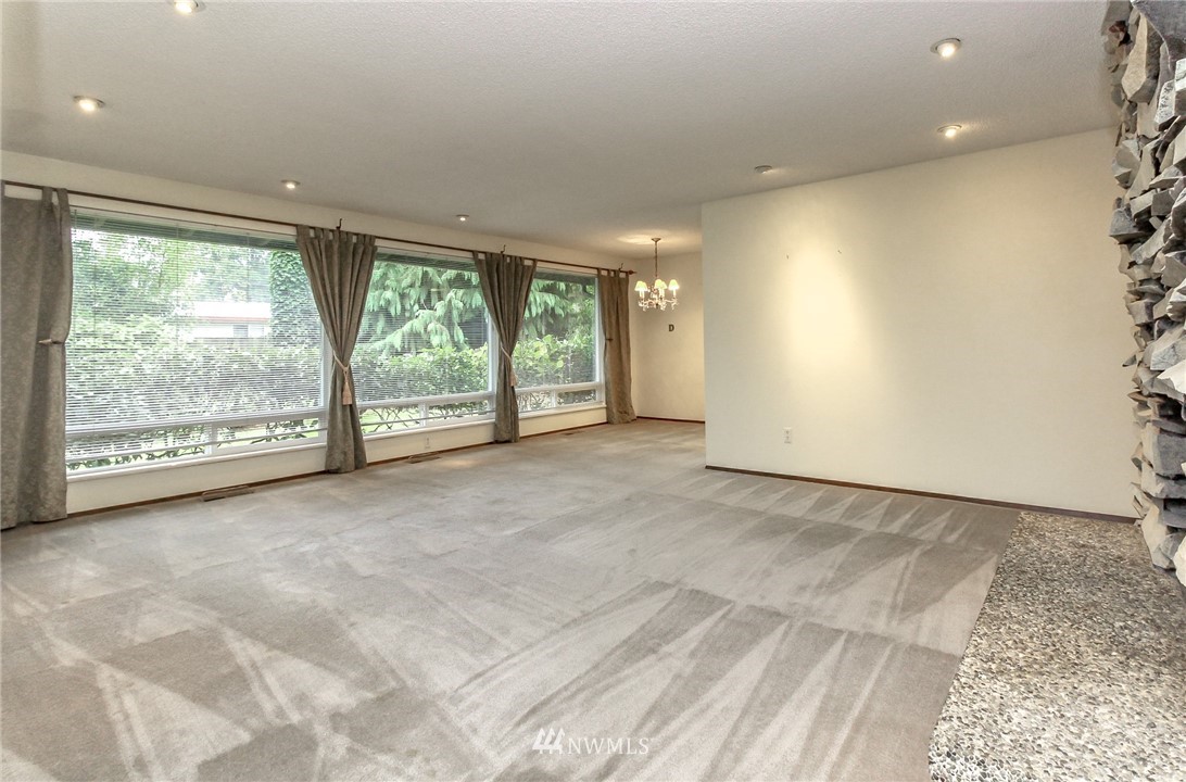 4615 Northeast 24th Street Renton, WA 98059 - Photo 6 of 40 an empty room with large windows and yard