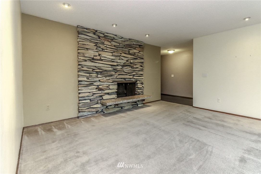 4615 Northeast 24th Street Renton, WA 98059 - Photo 10 of 40 an empty room with a fireplace