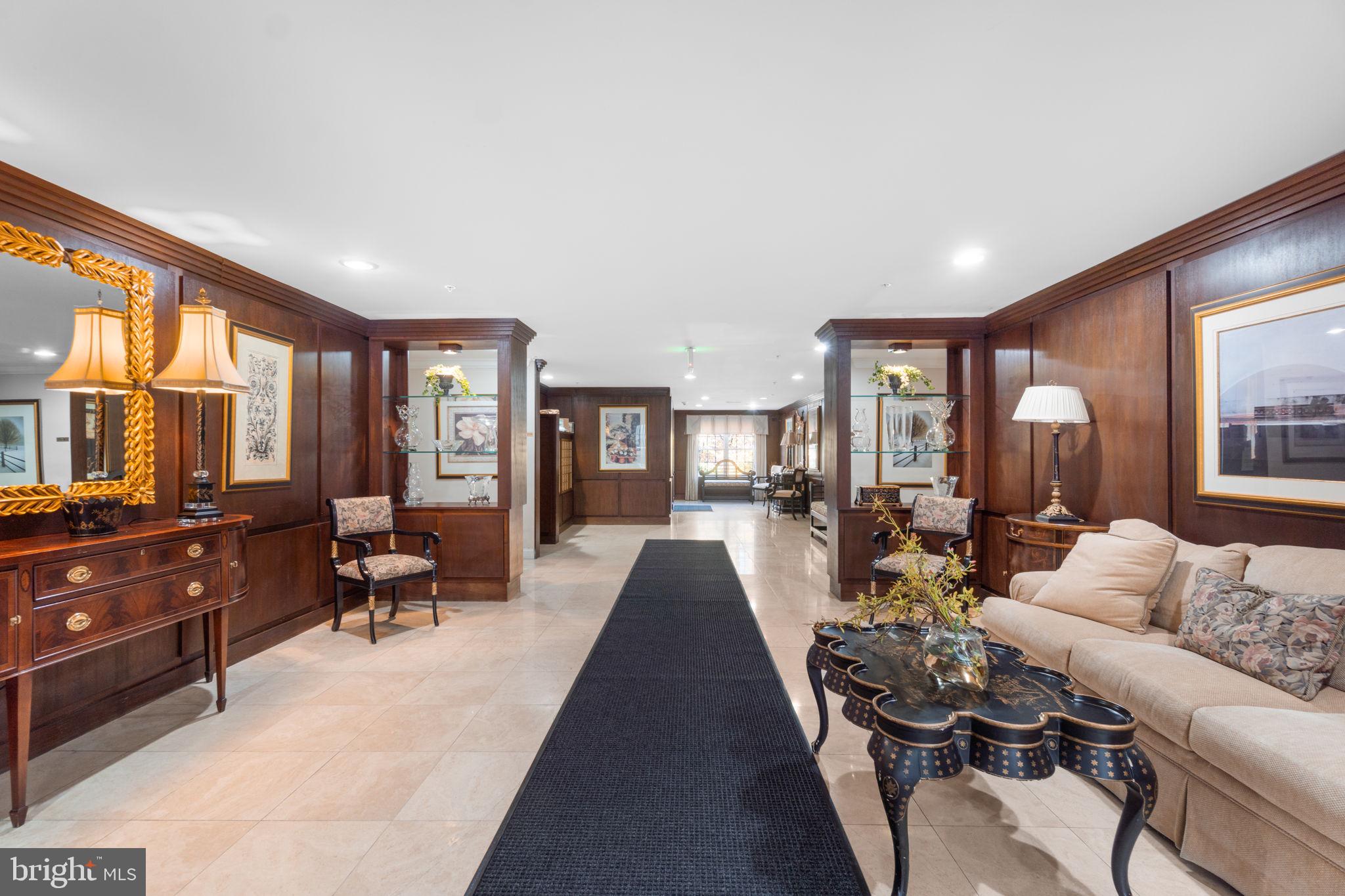 9510 Coyle Road, Unit 109 Owings Mills, MD 21117 - Photo 3 of 41 a living room with furniture fireplace and a large window