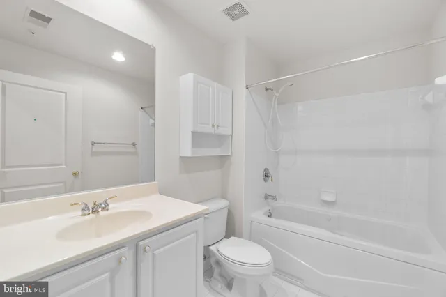 a bathroom with a sink toilet vanity and shower