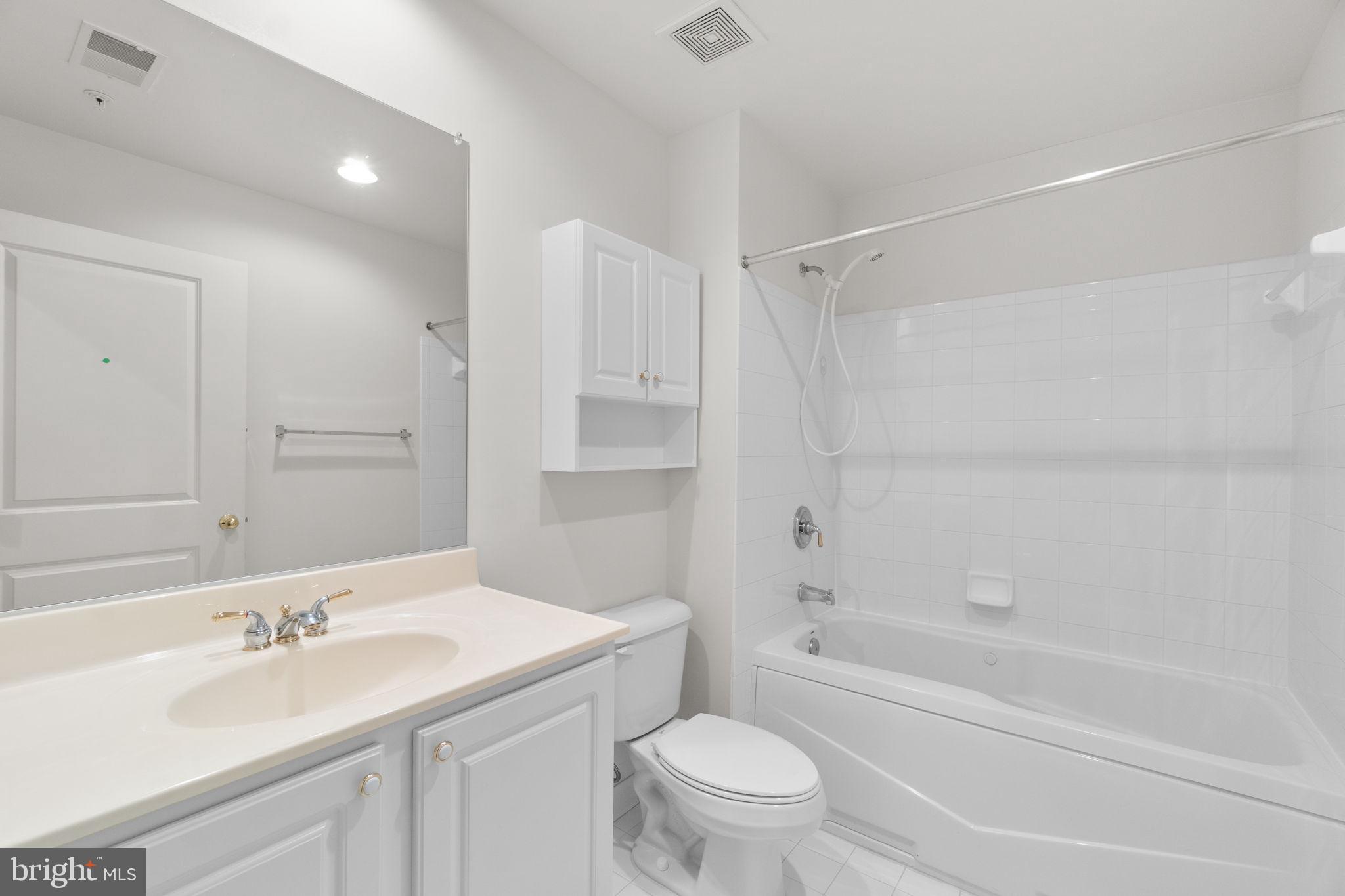 9510 Coyle Road, Unit 109 Owings Mills, MD 21117 - Photo 31 of 41 a bathroom with a sink toilet vanity and shower