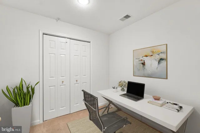 a view of a workspace with furniture and a potted plant
