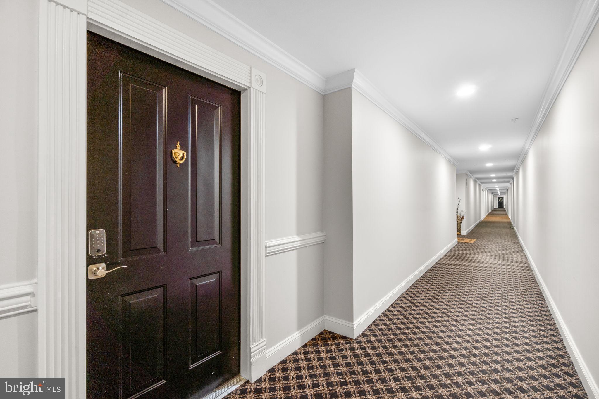 9510 Coyle Road, Unit 109 Owings Mills, MD 21117 - Photo 4 of 41 a view of a hallway with wooden floor