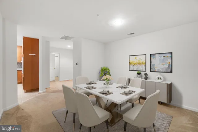 a view of a dining room with furniture and a potted plant