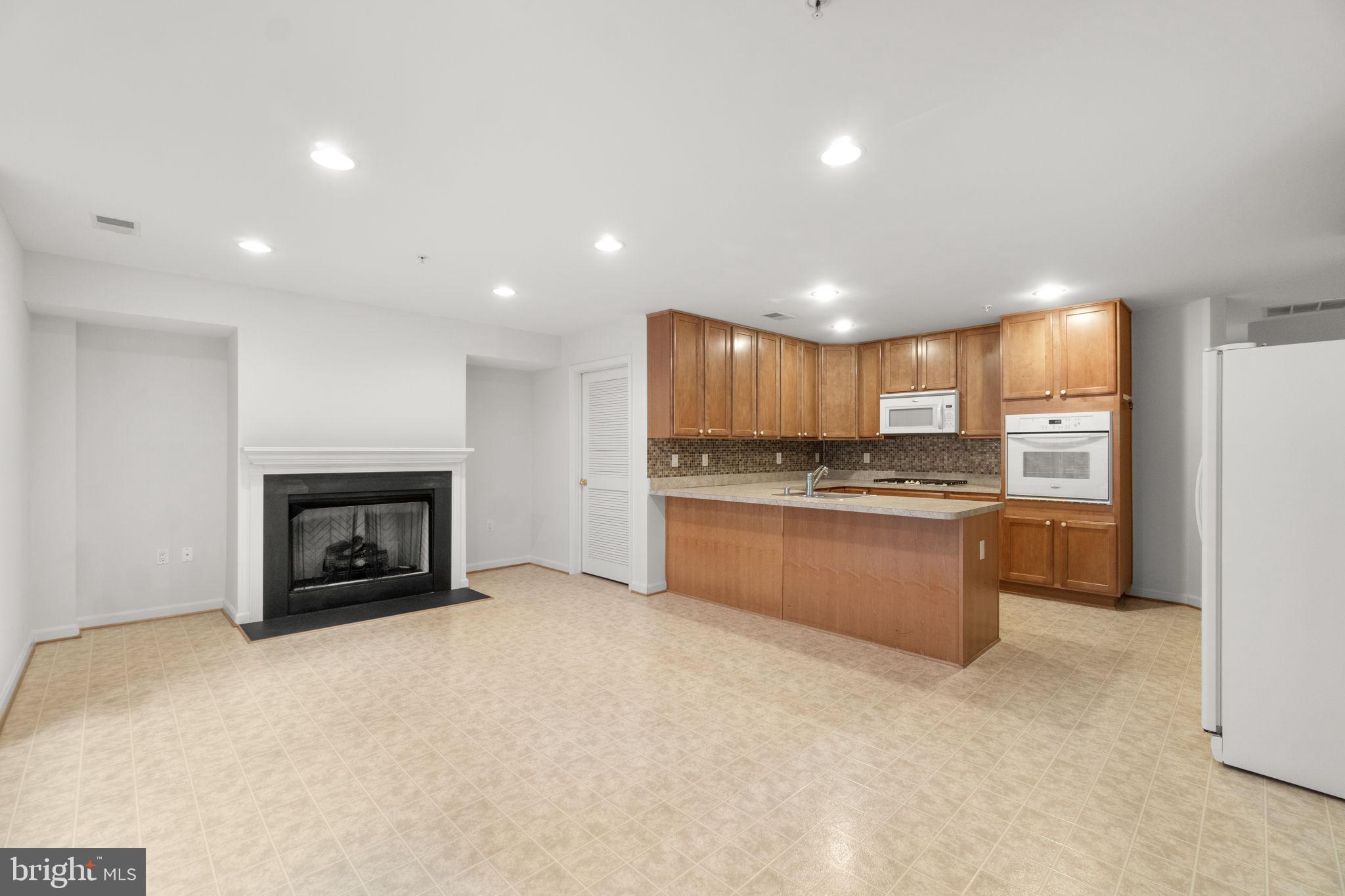 9510 Coyle Road, Unit 109 Owings Mills, MD 21117 - Photo 10 of 41 a large kitchen with a stove and a refrigerator