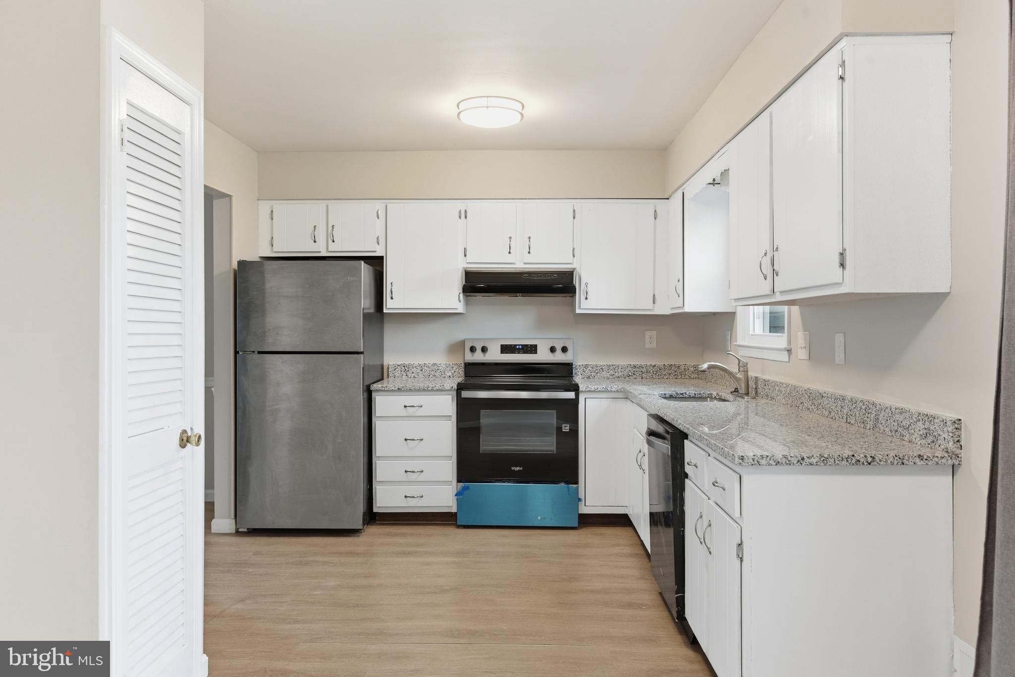 505 Montgomery Street Laurel, MD 20707 - Photo 11 of 30 a kitchen with a refrigerator sink and cabinets