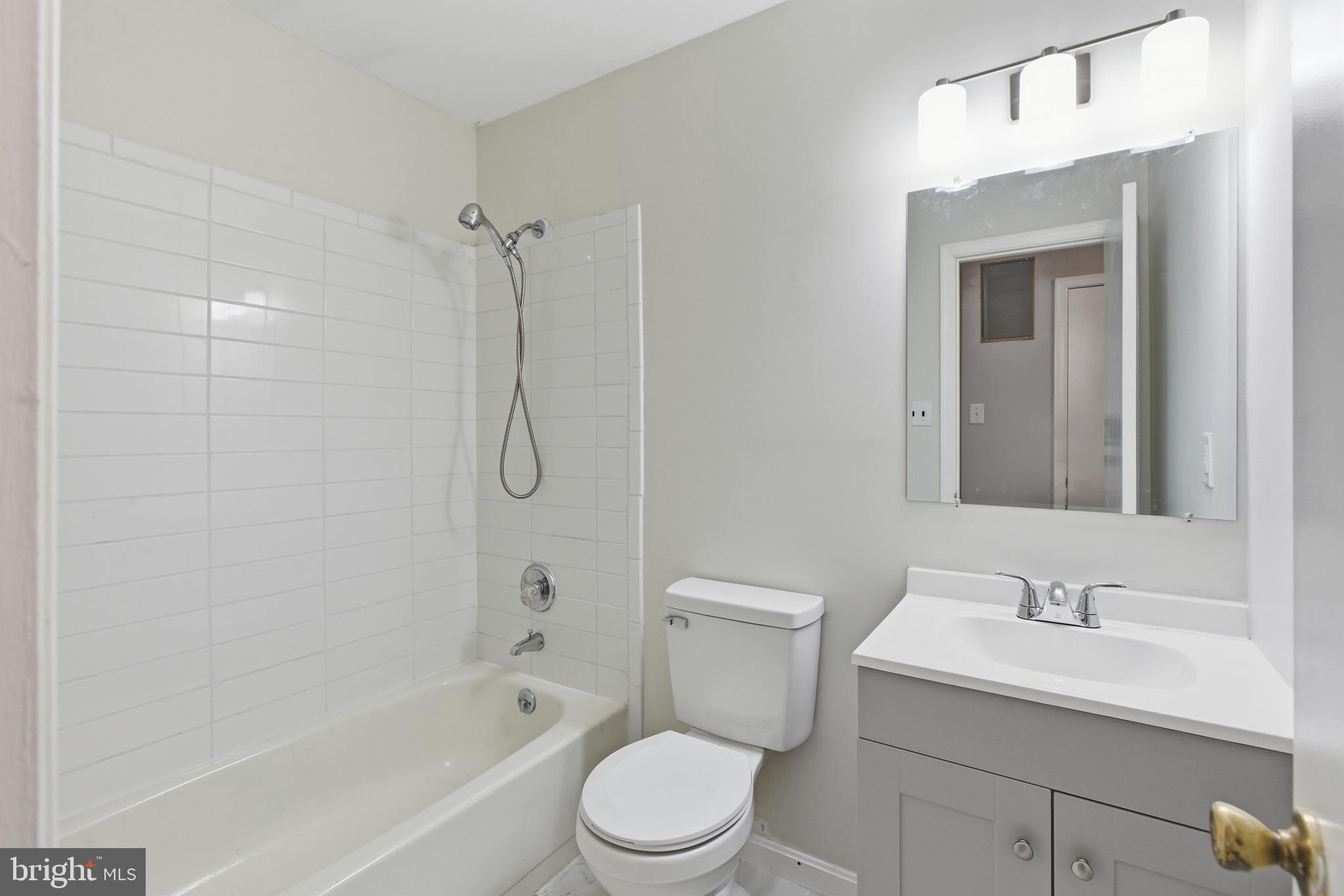 505 Montgomery Street Laurel, MD 20707 - Photo 23 of 30 a bathroom with a sink toilet vanity and shower