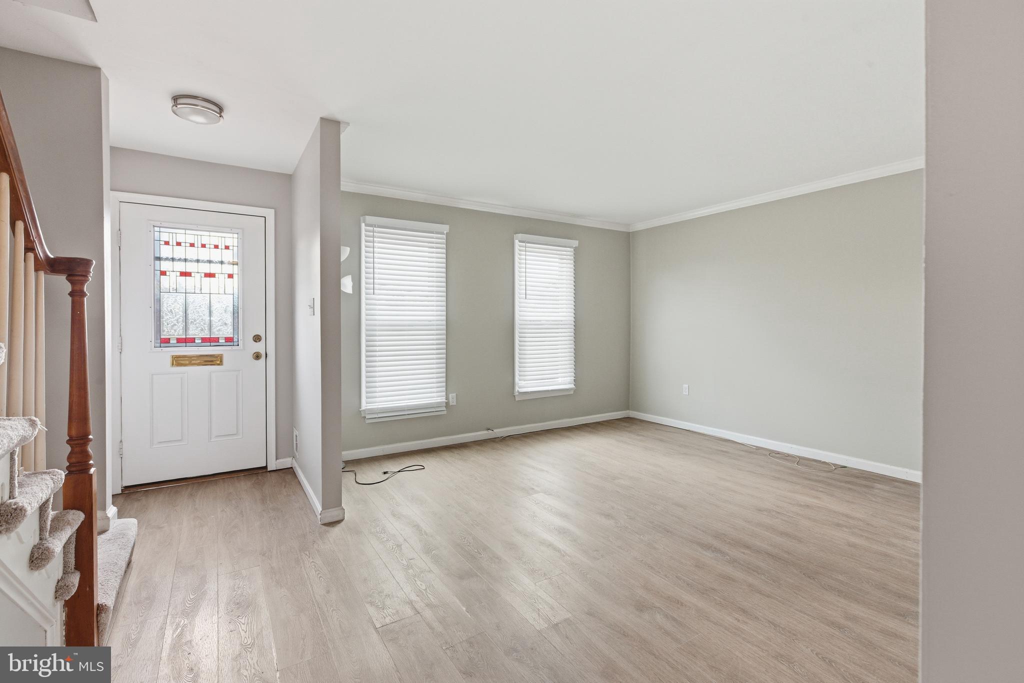505 Montgomery Street Laurel, MD 20707 - Photo 3 of 30 an empty room with wooden floor and windows