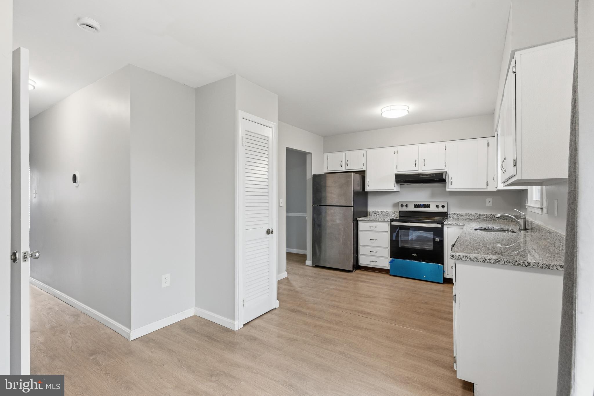 505 Montgomery Street Laurel, MD 20707 - Photo 10 of 30 a kitchen with stainless steel appliances a refrigerator and a stove top oven