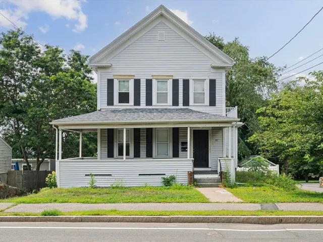 a house that has a tree in front of it