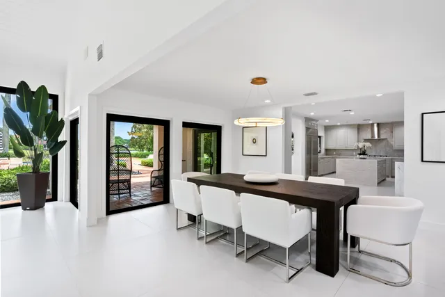 a living room with a large window and pool table