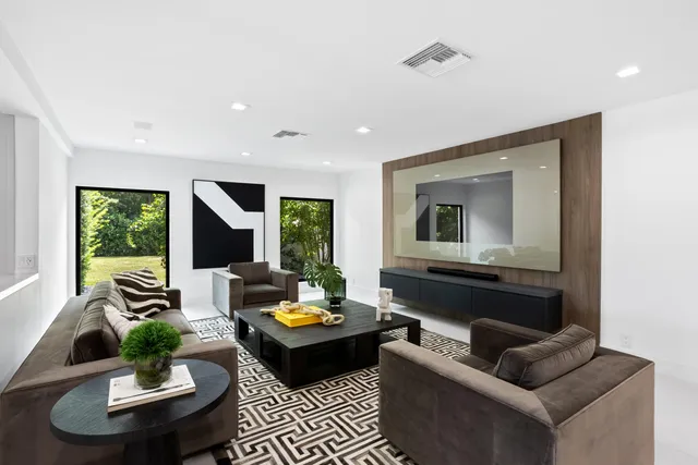 a living room with hardwood floor and large window