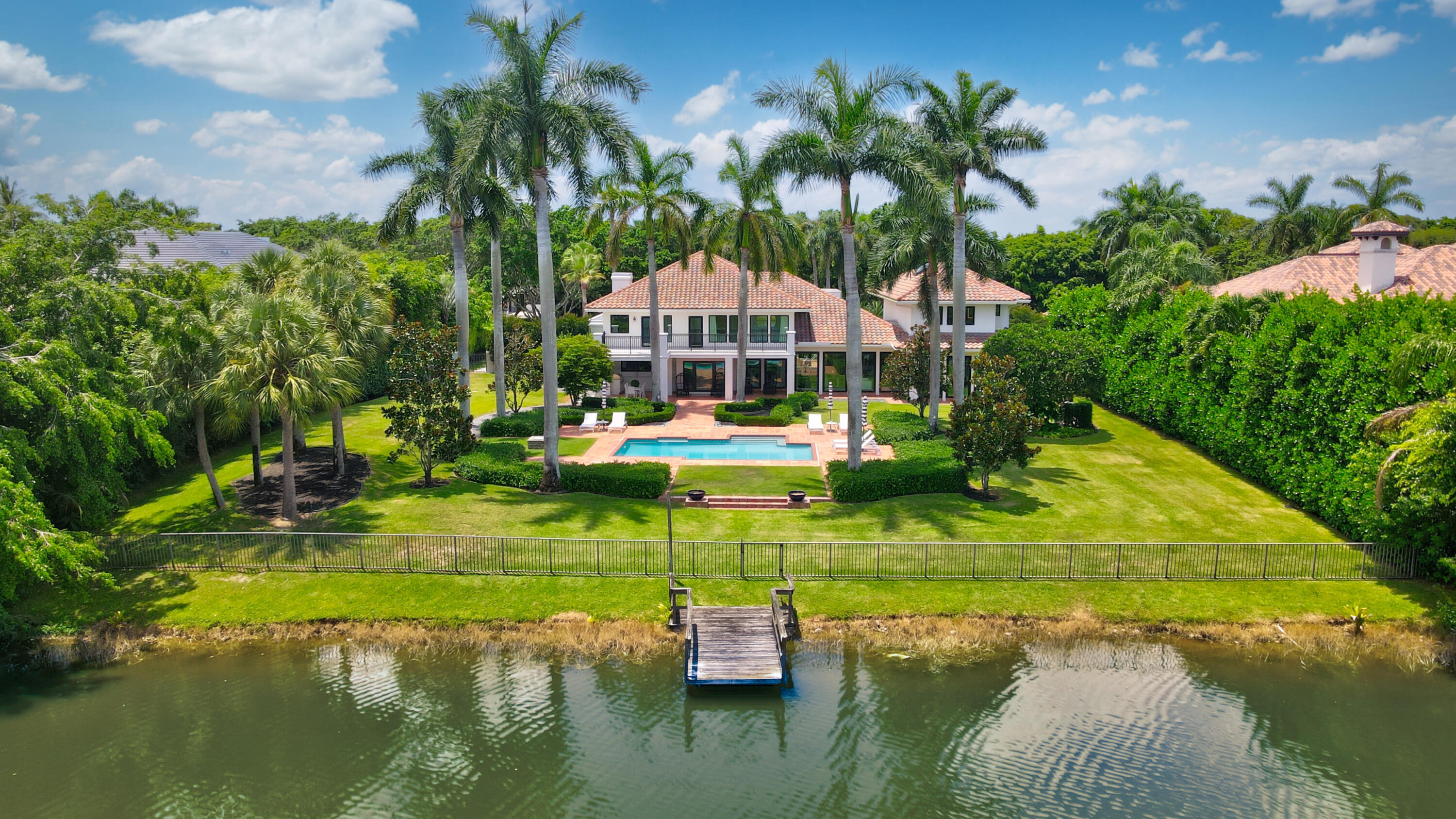18743 Long Lake Drive Boca Raton, FL 33496 - Photo 3 of 85 a view of a lake with a house in the background