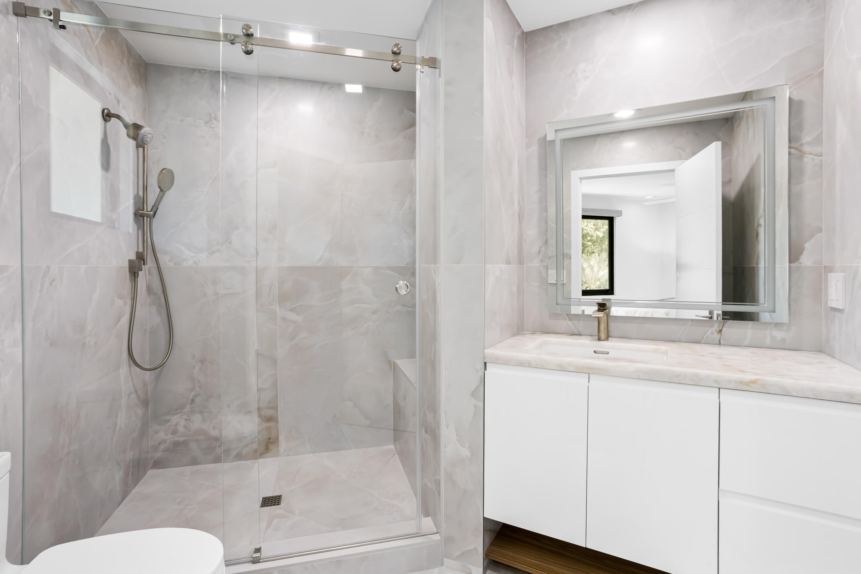 18743 Long Lake Drive Boca Raton, FL 33496 - Photo 38 of 85 a bathroom with a granite countertop sink a mirror a vanity and shower