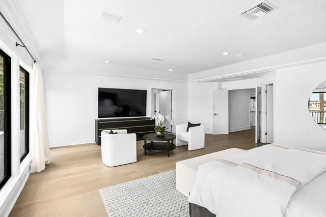 an aerial view of ocean and residential houses with outdoor space