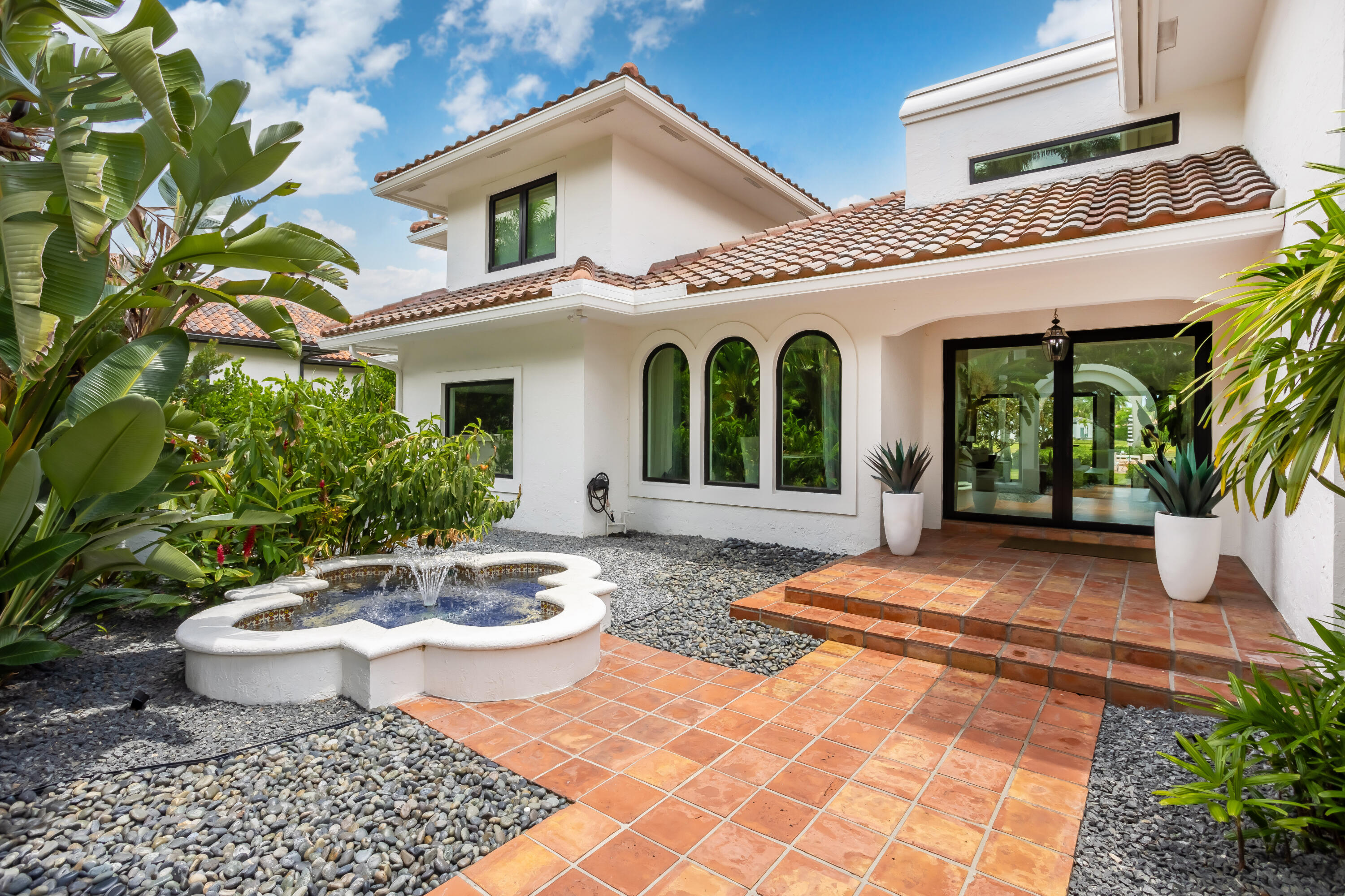18743 Long Lake Drive Boca Raton, FL 33496 - Photo 9 of 85 a view of a patio with table and chairs potted plants and floor to ceiling window