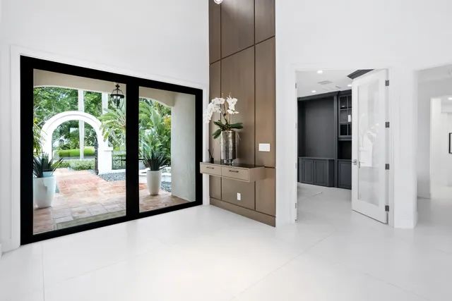 a living room with furniture and large windows