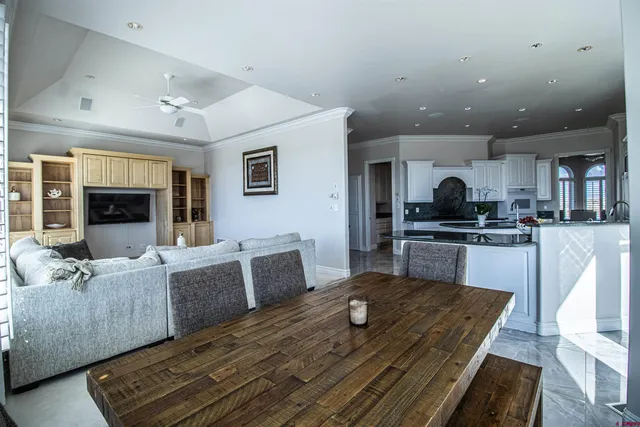 a living room with furniture kitchen and a table