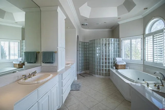 a bathroom with a tub sink and mirror
