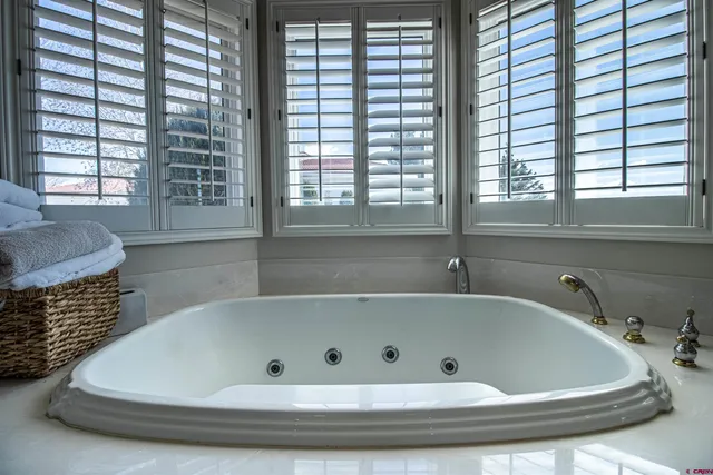 a bathroom with bathtub and window