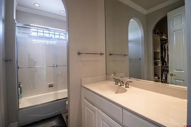a bathroom with a tub sink and mirror