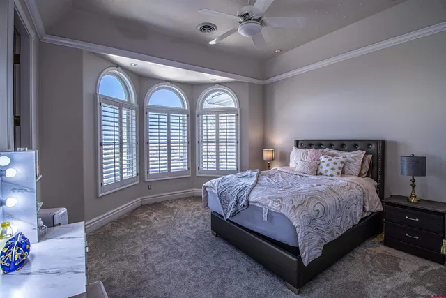 a spacious bedroom with a bed and a large dresser