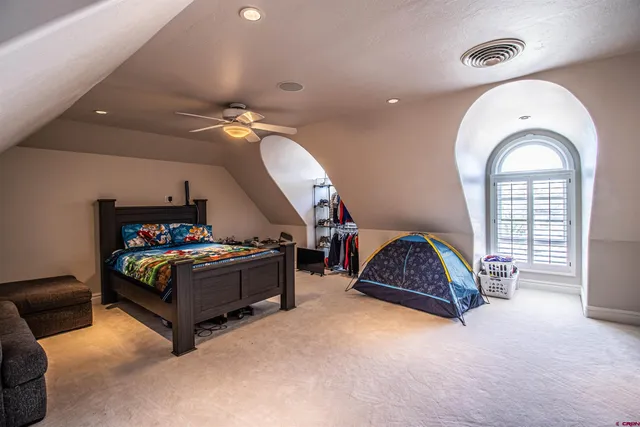 a bedroom with a bed and a chandelier