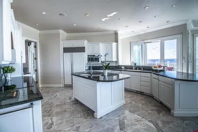a kitchen with stainless steel appliances granite countertop a sink stove and cabinets