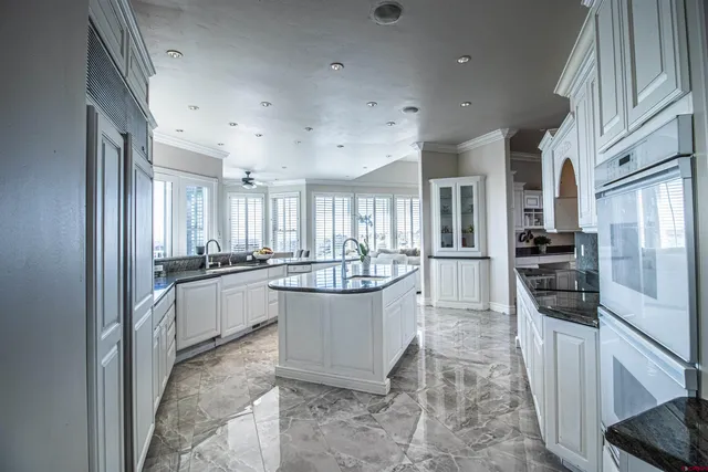 a large kitchen with a large window and stainless steel appliances
