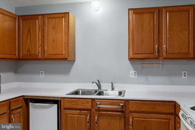 a kitchen with a sink cabinets and wooden floor