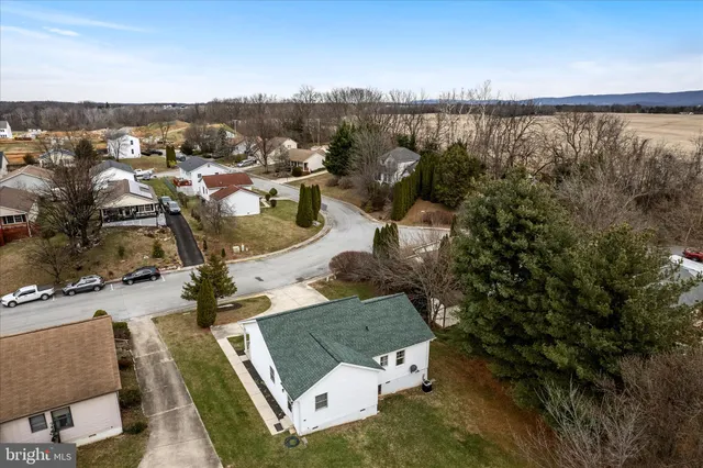 an aerial view of residential house with outdoor space and ocean view