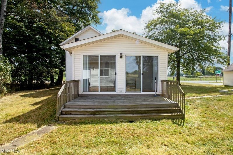 8984 Spencer Road Homerville, OH 44235 - Photo 10 of 27 Rear view of house with a deck and a yard