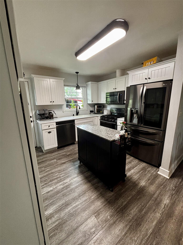 1032 Windy Ridge Drive Bedford, VA 24523 - Photo 8 of 27 a kitchen with a sink a microwave and cabinets