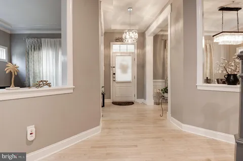 a view of entryway with wooden floor and stairs