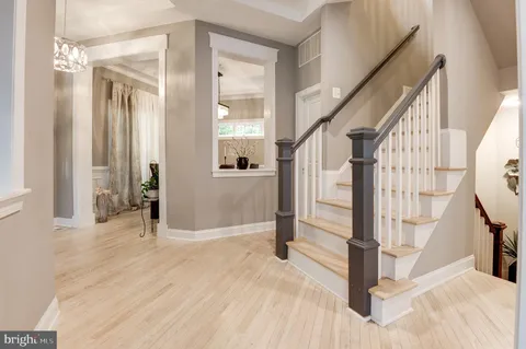a view of a hallway view with wooden floor and staircase
