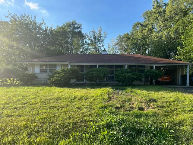 a view of house with backyard space and garden