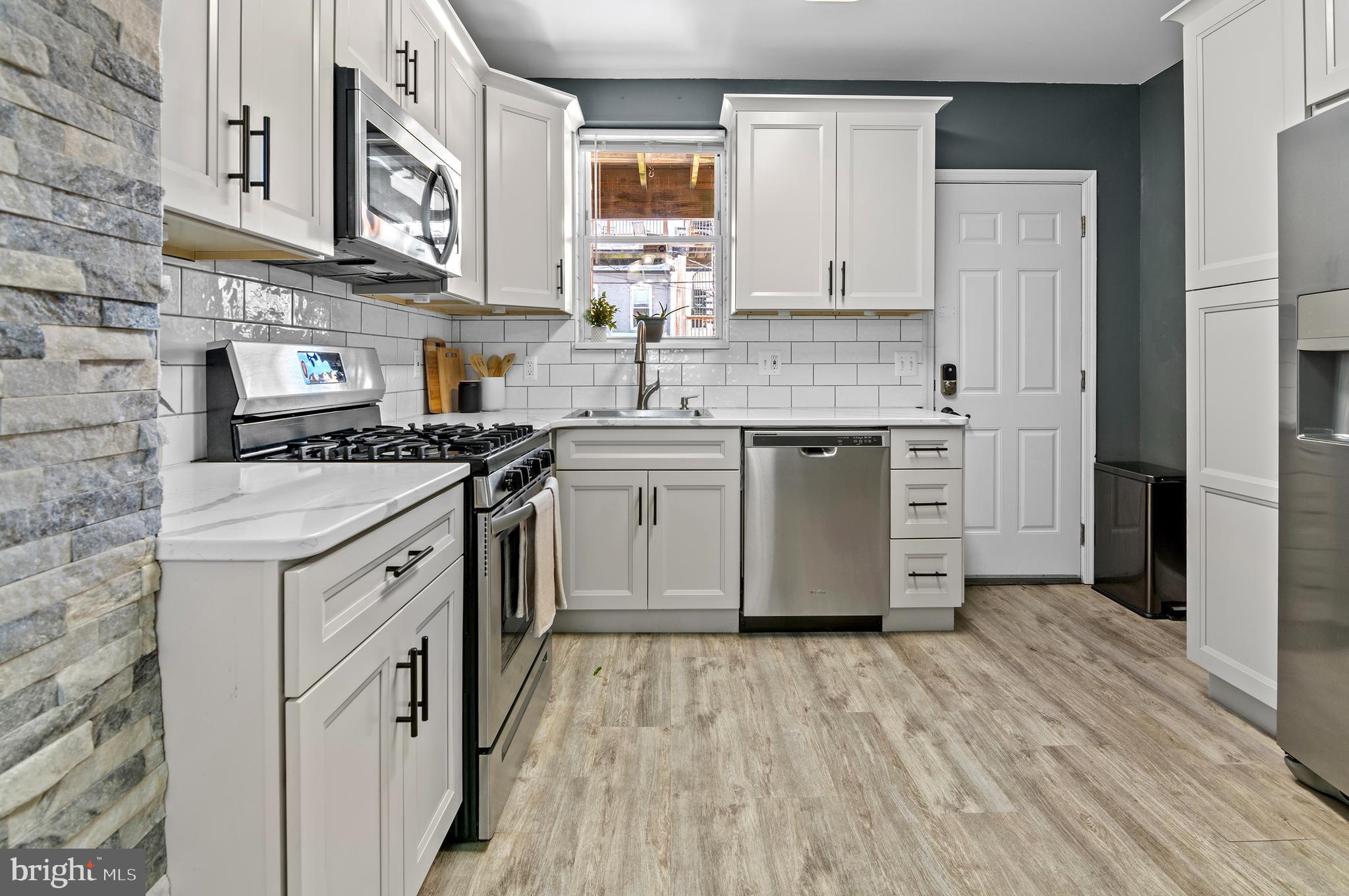 416 South Bouldin Street Baltimore, MD 21224 - Photo 14 of 45 a kitchen with stainless steel appliances granite countertop a stove and a sink