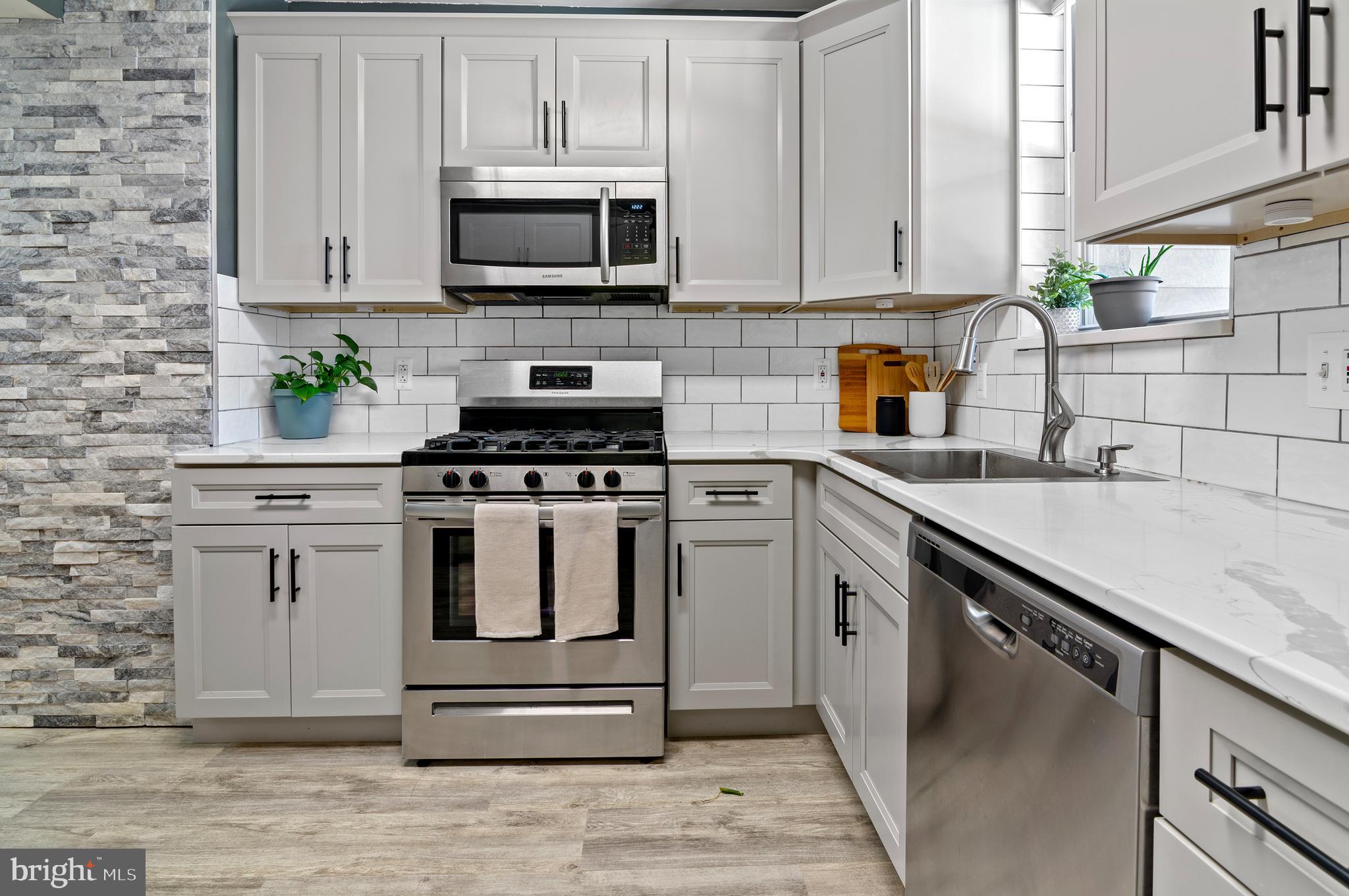 416 South Bouldin Street Baltimore, MD 21224 - Photo 17 of 45 a kitchen with granite countertop white cabinets and appliances