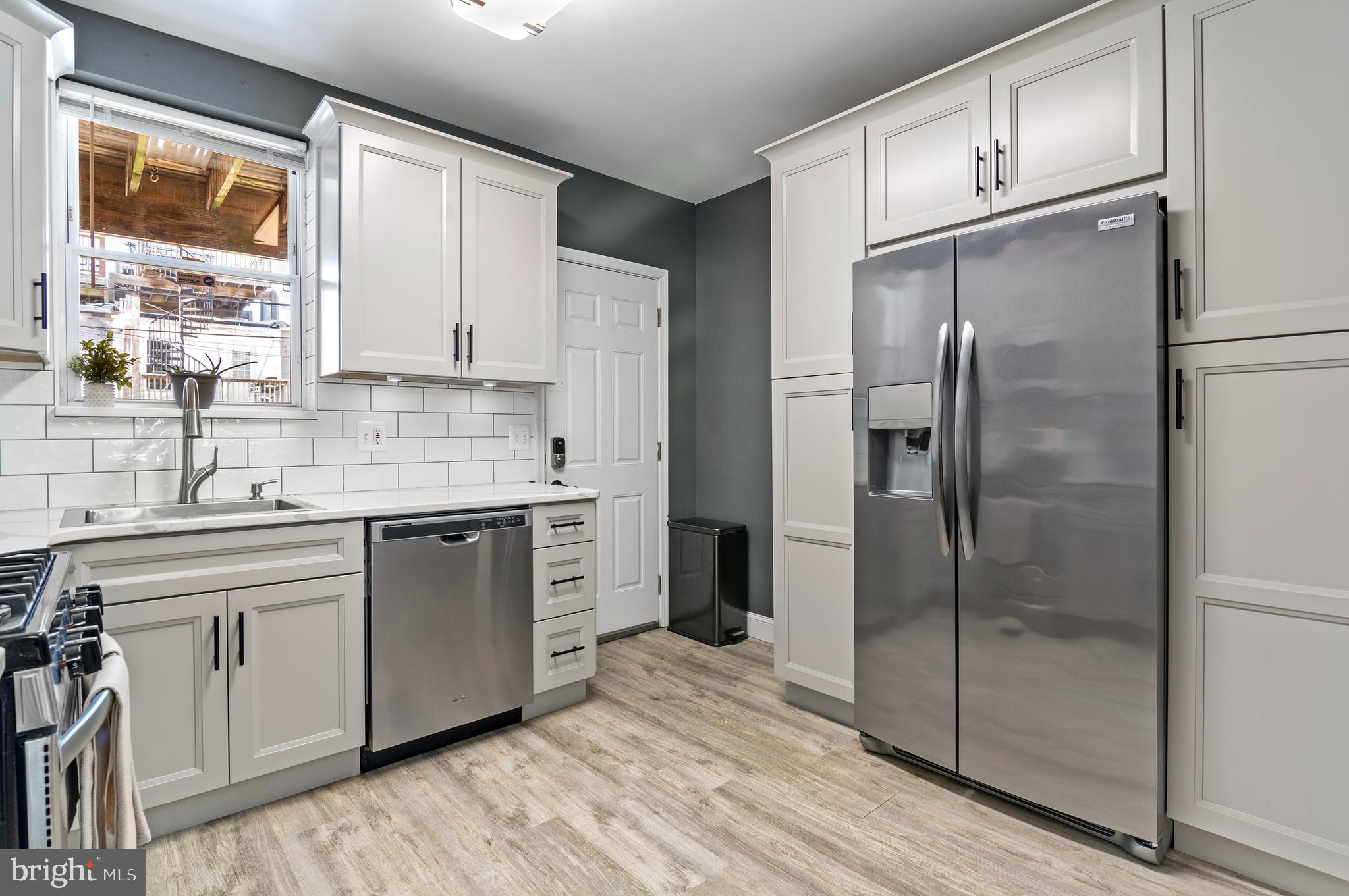 416 South Bouldin Street Baltimore, MD 21224 - Photo 19 of 45 a kitchen with a refrigerator a sink and a window